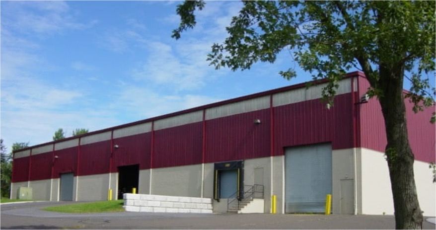 Exterior of the Philadelphia Badminton building, a maroon and cream industrial facility
