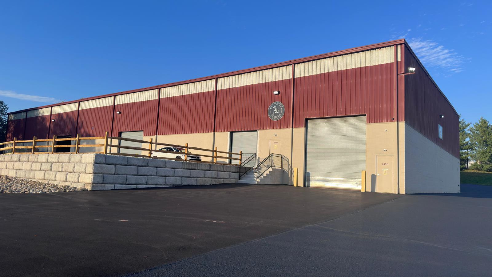 Exterior of the Philadelphia Badminton building, a maroon and cream industrial facility